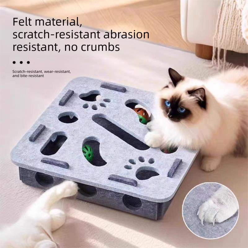 Ragdoll cat pawing at the grey square Felt Maze Cat Toy Box showing the scratch-resistant, wear-resistant felt material and hidden bell ball inside